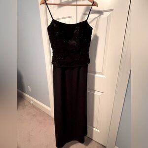 Black spaghetti strap formal dress with delicate beadwork on bodice.